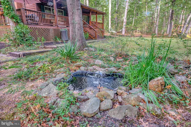 a front view of house with yard and trees in the background