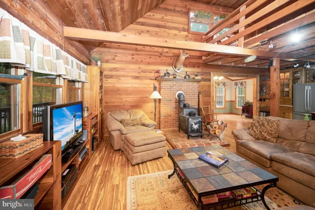 a living room with furniture a rug and white walls
