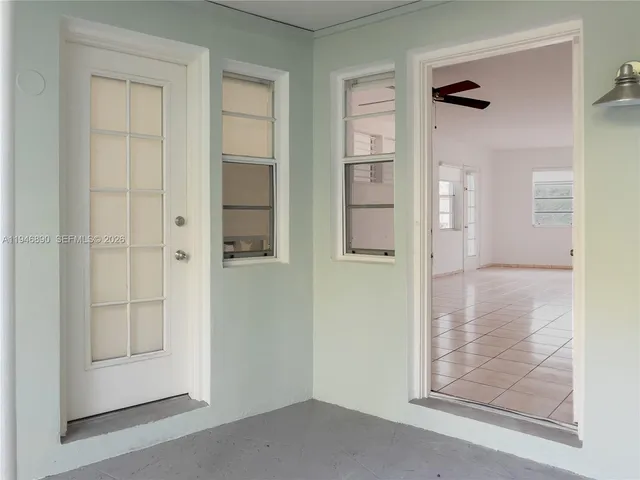 an empty room that has a wooden door