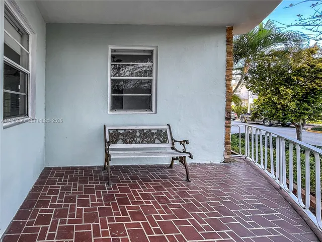 a bench sitting in front of a window