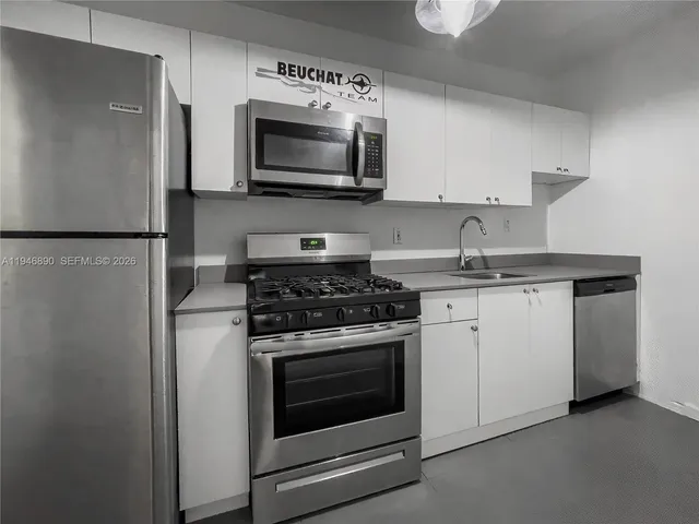 a kitchen with a stove microwave and refrigerator