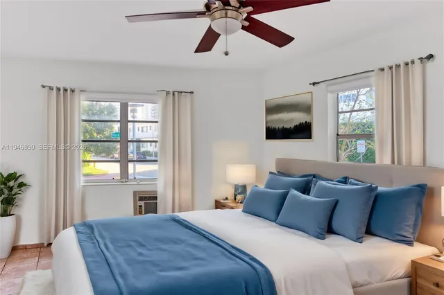 a bedroom with a large bed and a window