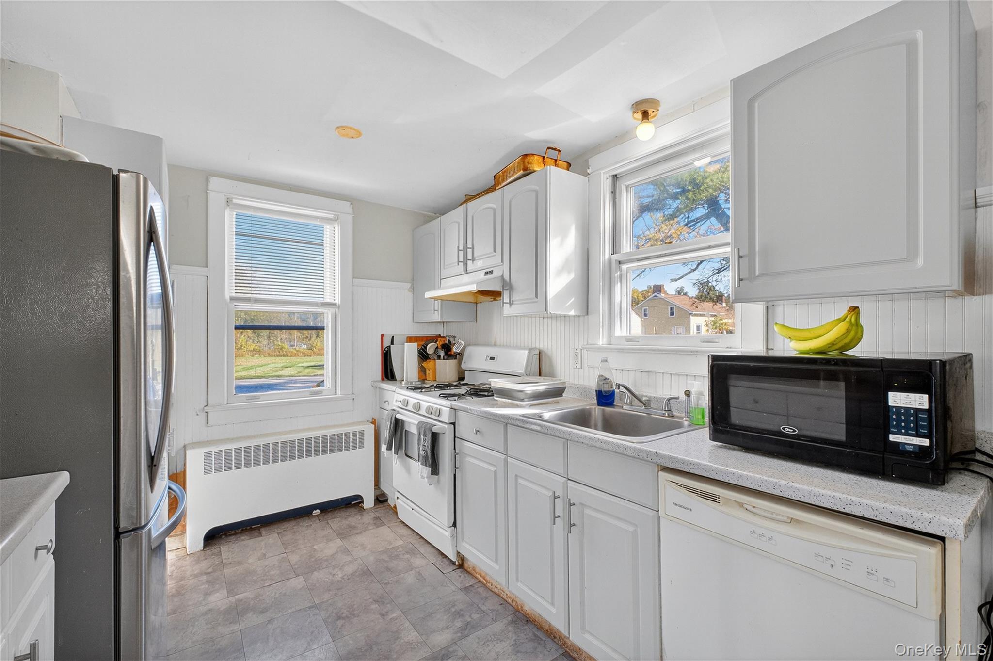 17 Fishkill Hook Road Hopewell Junction, NY 12533 - Photo 12 of 29 a kitchen with stainless steel appliances a stove a sink cabinets and a window