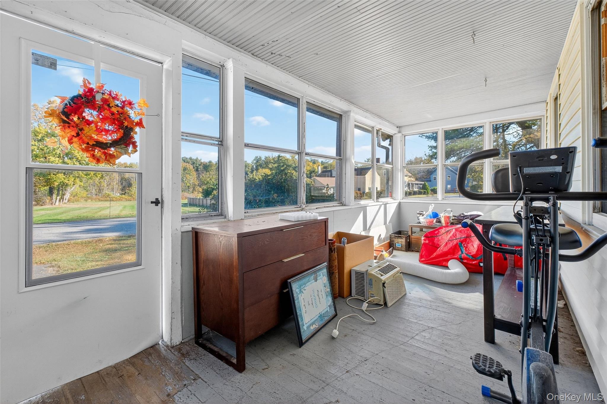 17 Fishkill Hook Road Hopewell Junction, NY 12533 - Photo 3 of 29 a living room with furniture a flat screen tv and a floor to ceiling window