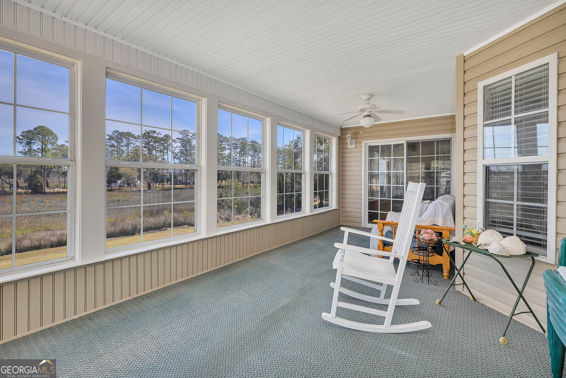 1056 Fiddler Trace Townsend, GA 31331 - Photo 13 of 36 a dining room with wooden floor and white walls