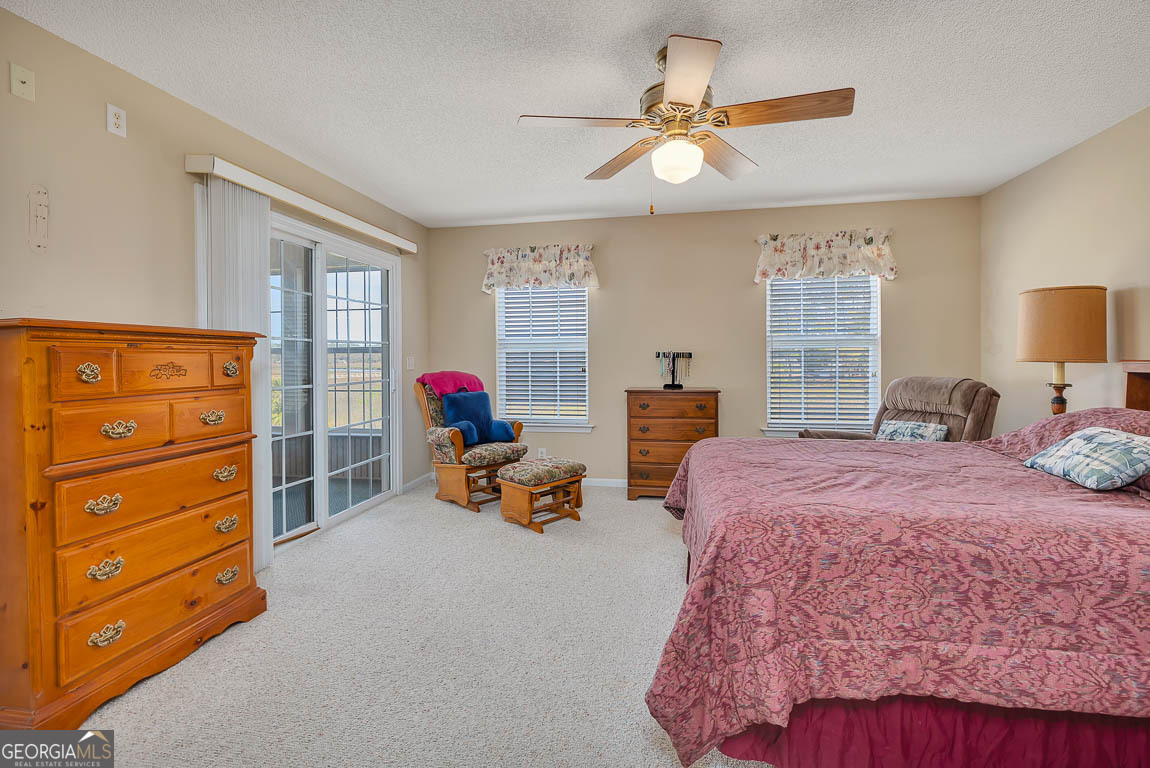 1056 Fiddler Trace Townsend, GA 31331 - Photo 18 of 36 a bedroom with a bed and furniture