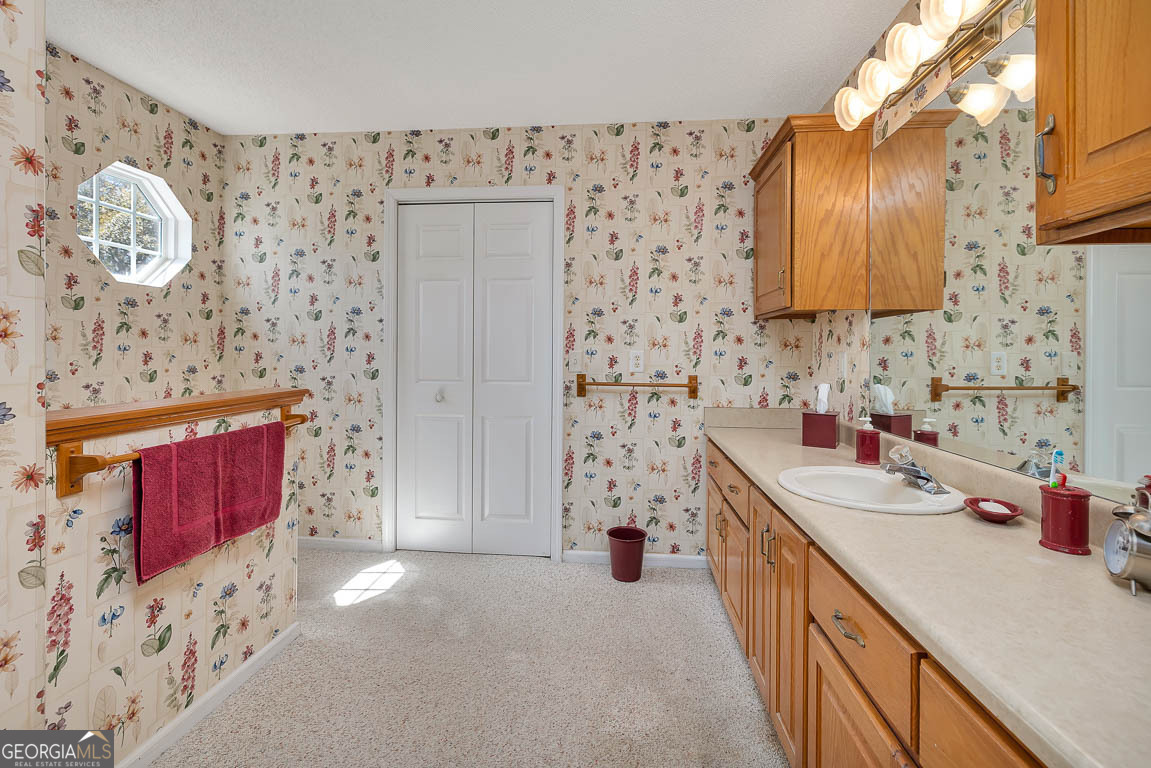 1056 Fiddler Trace Townsend, GA 31331 - Photo 20 of 36 a bathroom with mirror sink and vanity