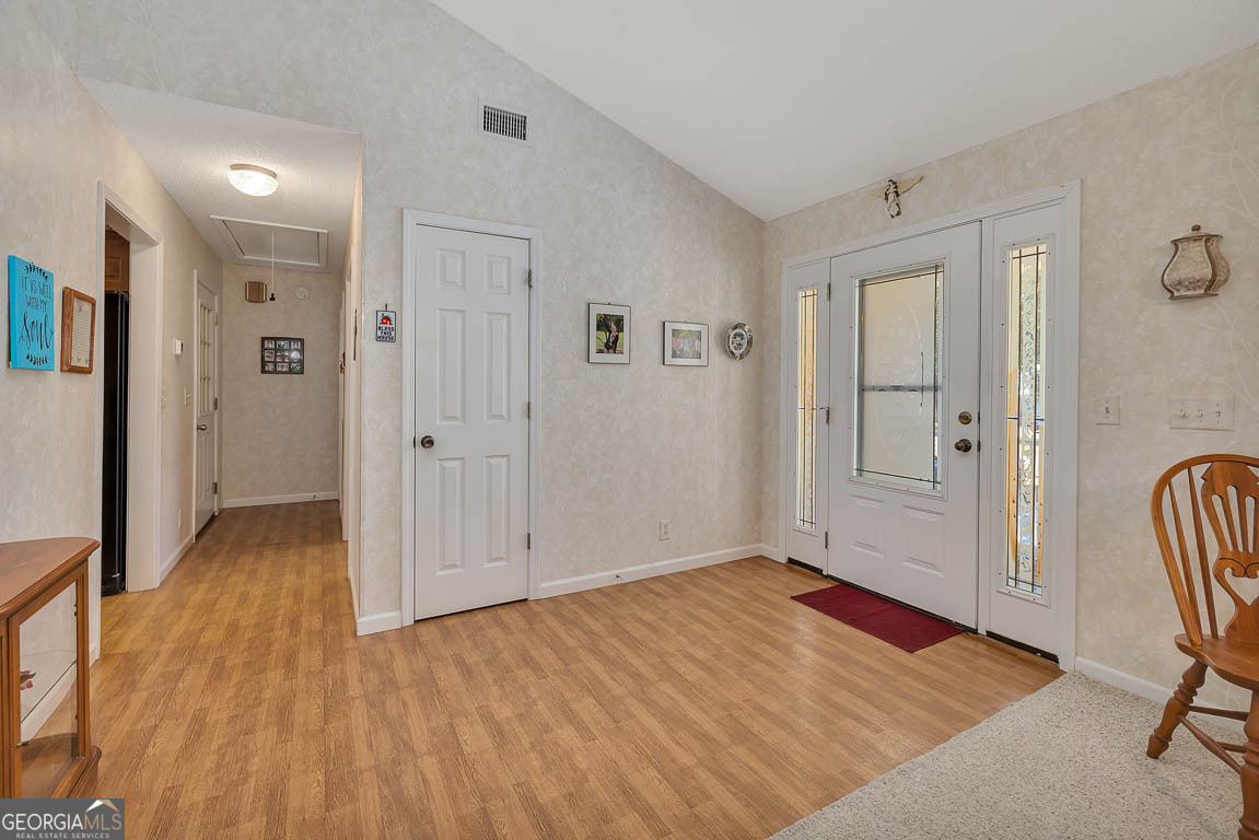 1056 Fiddler Trace Townsend, GA 31331 - Photo 2 of 36 a view of a livingroom with wooden floor and bathroom