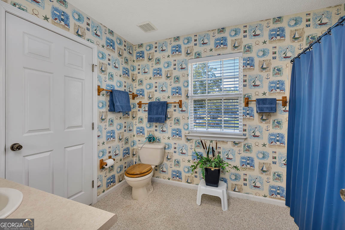 1056 Fiddler Trace Townsend, GA 31331 - Photo 23 of 36 a view of a bedroom with a potted plant and a window