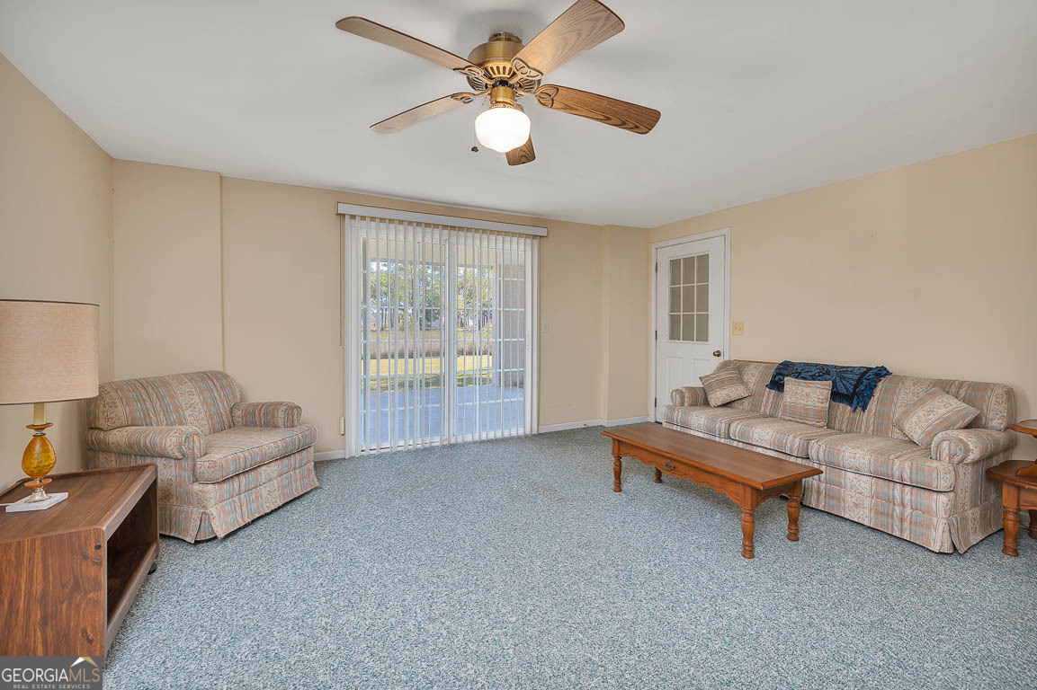 1056 Fiddler Trace Townsend, GA 31331 - Photo 28 of 36 a living room with furniture and a ceiling fan