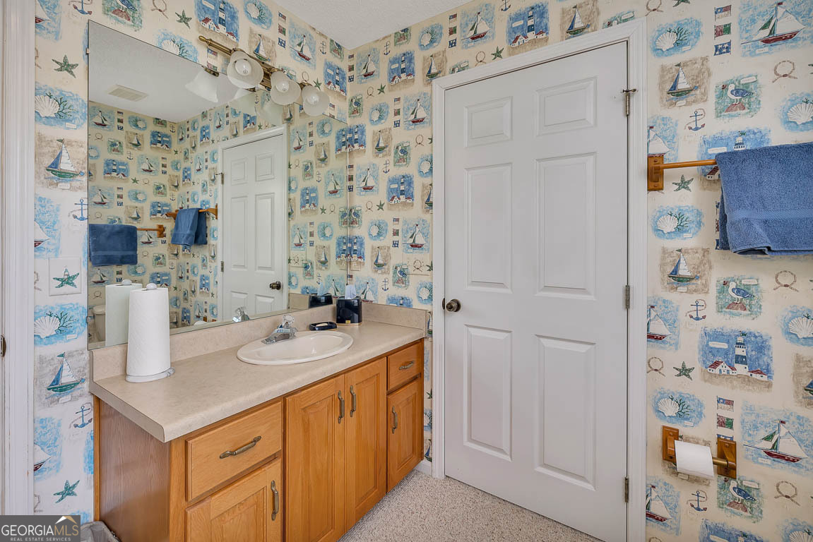 1056 Fiddler Trace Townsend, GA 31331 - Photo 30 of 36 a bathroom with a sink and a mirror