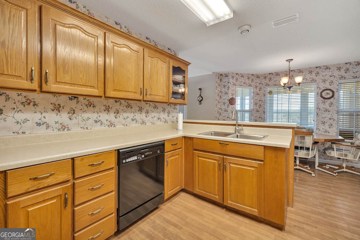 1056 Fiddler Trace Townsend, GA 31331 - Photo 3 of 36 a kitchen with stainless steel appliances granite countertop a sink stove and cabinets