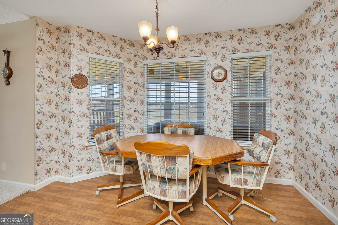 1056 Fiddler Trace Townsend, GA 31331 - Photo 8 of 36 a view of a dining room with furniture and chandelier