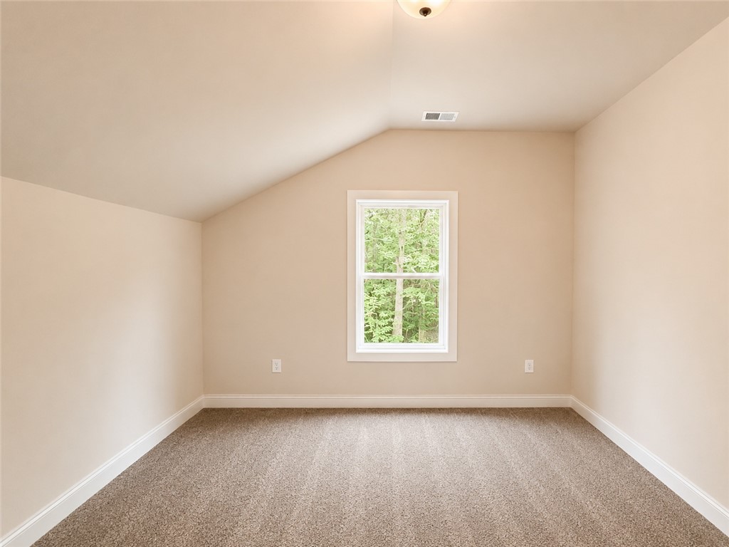 328 Point Road Westminster, SC 29693 - Photo 17 of 24 Well-lit and tranquil bedroom with a tree-filled outdoor perspective from its single window.