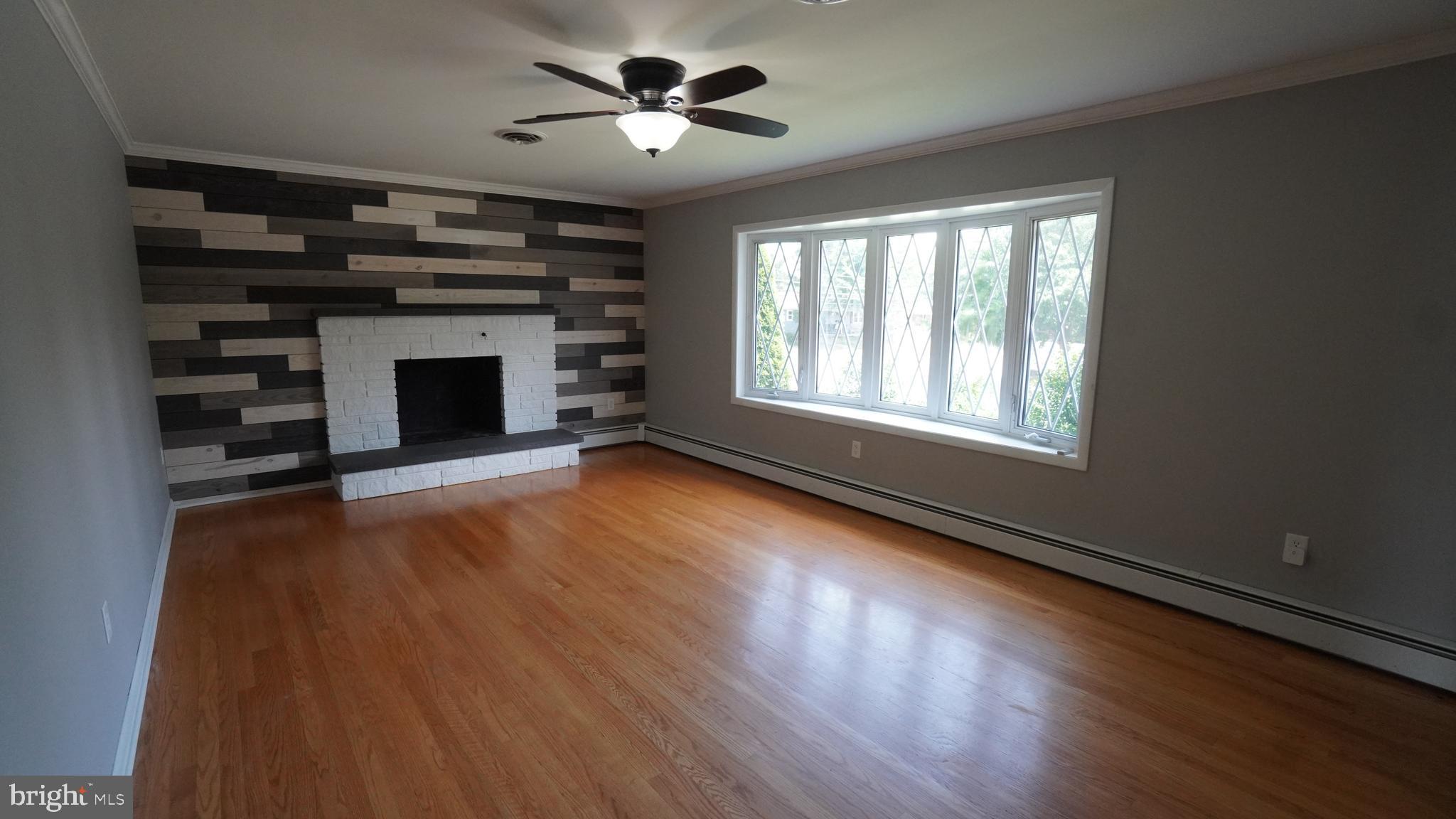 367 Devonshire Road Hagerstown, MD 21740 - Photo 11 of 35 a view of an empty room with wooden floor fireplace and a window
