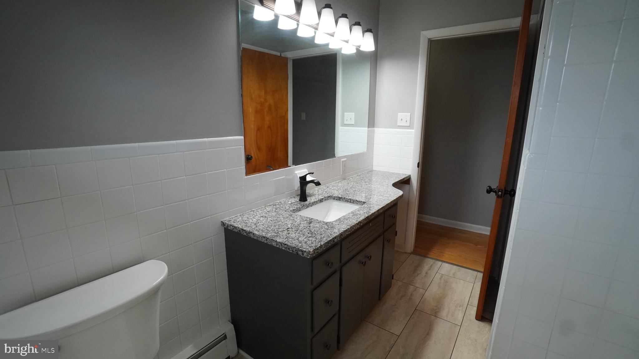 367 Devonshire Road Hagerstown, MD 21740 - Photo 18 of 35 a bathroom with a granite countertop sink toilet and mirror