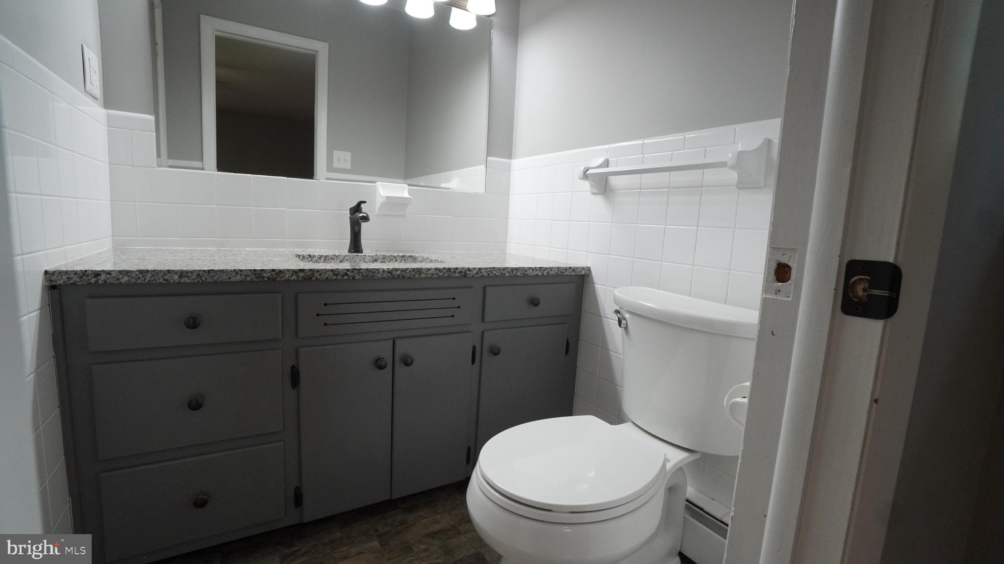 367 Devonshire Road Hagerstown, MD 21740 - Photo 22 of 35 a bathroom with a granite countertop toilet sink and mirror