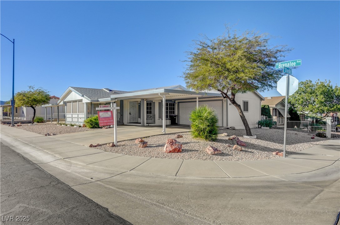 Single story home featuring concrete driveway and a garage