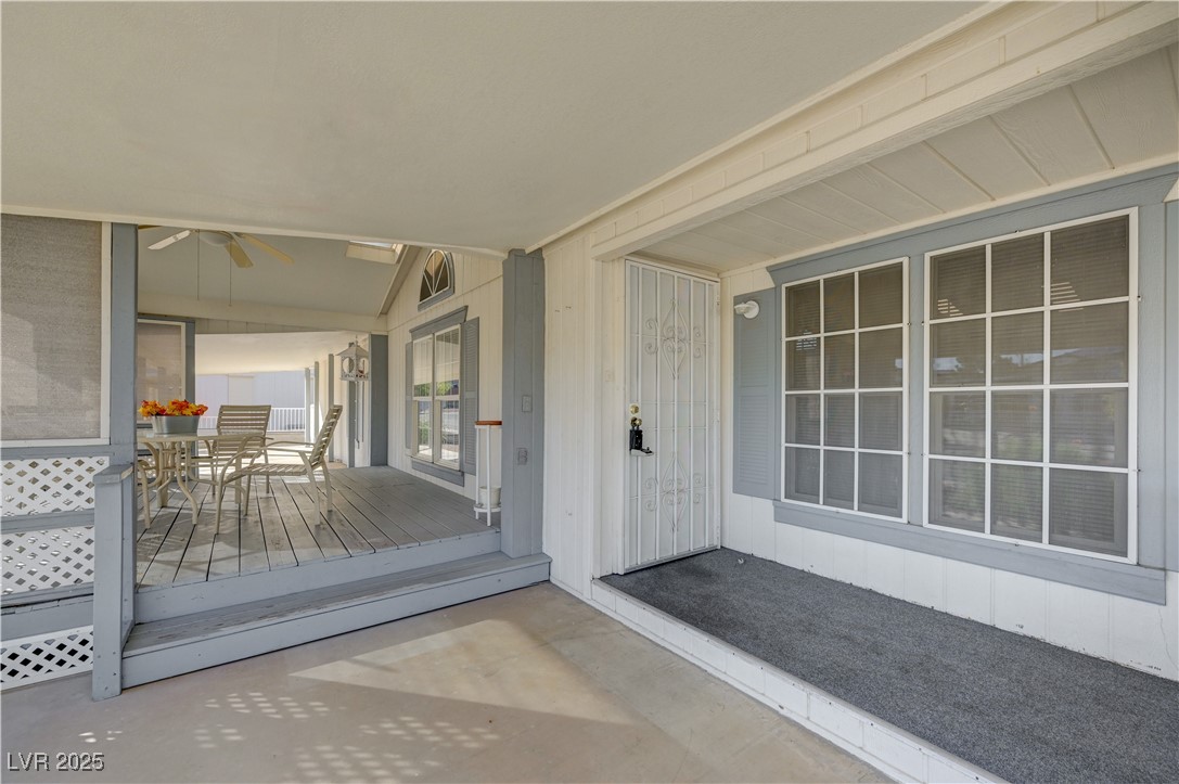 2011 Darla Street Henderson, NV 89002 - Photo 4 of 44 Entrance to property featuring outdoor dining area, a wooden deck, and a ceiling fan