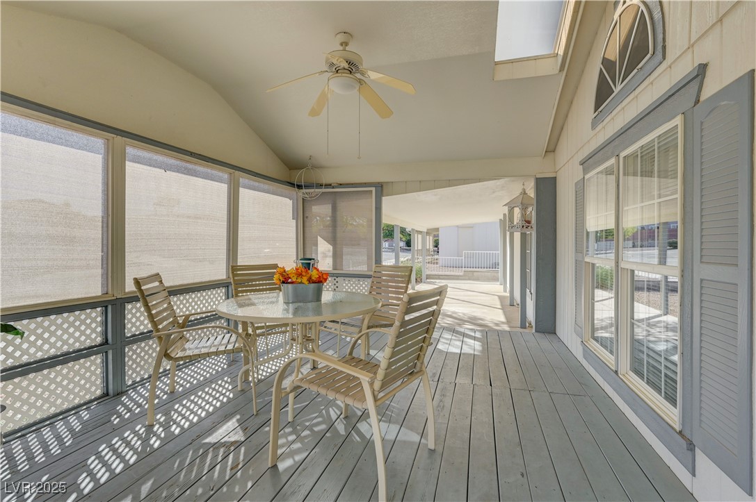 2011 Darla Street Henderson, NV 89002 - Photo 5 of 44 Sunroom featuring vaulted ceiling, outdoor dining space, healthy amount of natural light, and a ceiling fan