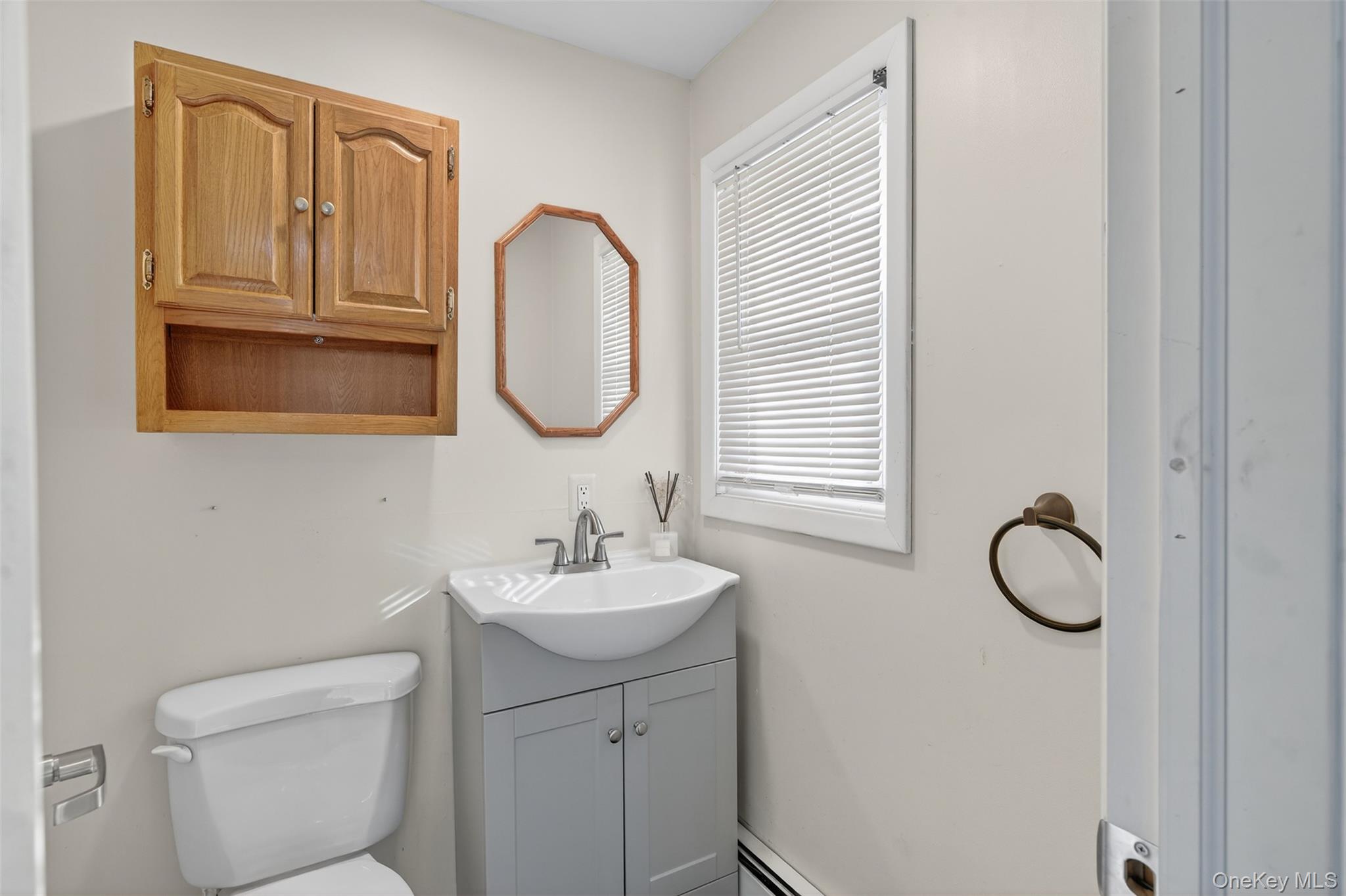 95 Sutton Park Road Poughkeepsie, NY 12603 - Photo 12 of 26 a bathroom with a toilet sink and mirror