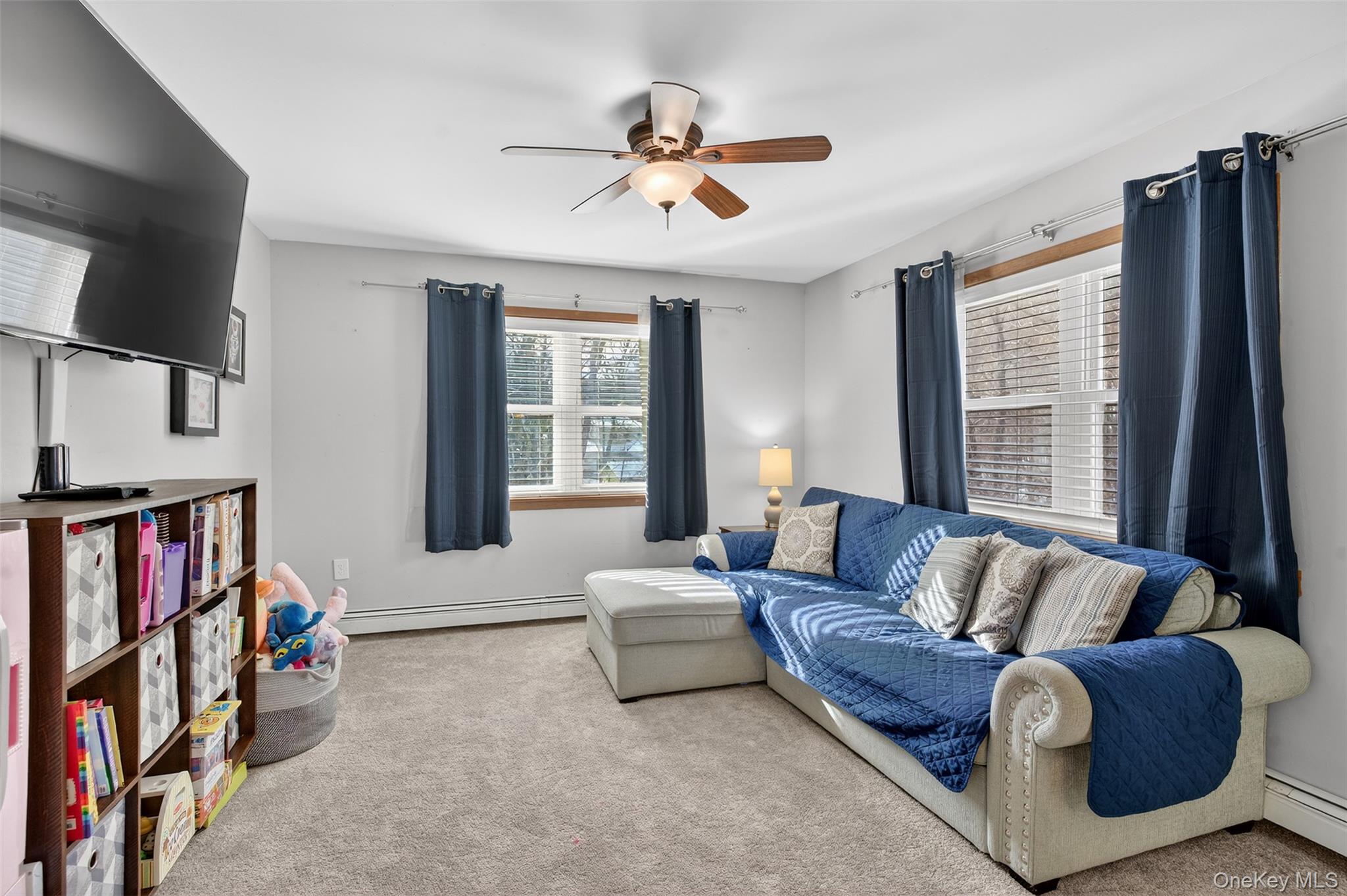 95 Sutton Park Road Poughkeepsie, NY 12603 - Photo 16 of 26 a living room with furniture ceiling fan and a window