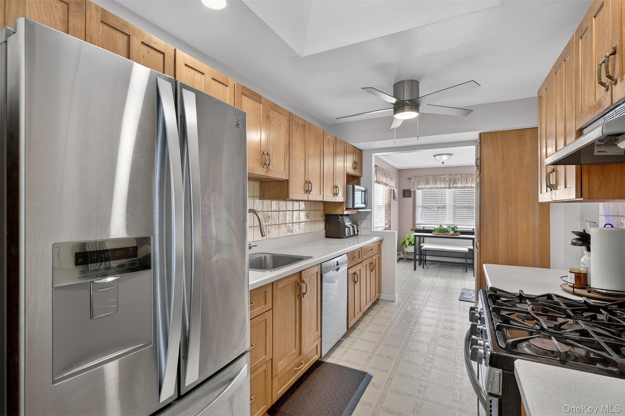 95 Sutton Park Road Poughkeepsie, NY 12603 - Photo 7 of 26 a kitchen with stainless steel appliances a sink stove and refrigerator