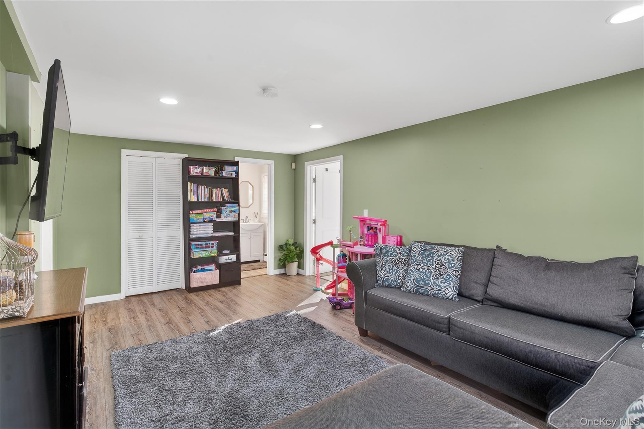 95 Sutton Park Road Poughkeepsie, NY 12603 - Photo 8 of 26 a living room with a couch and a flat screen tv