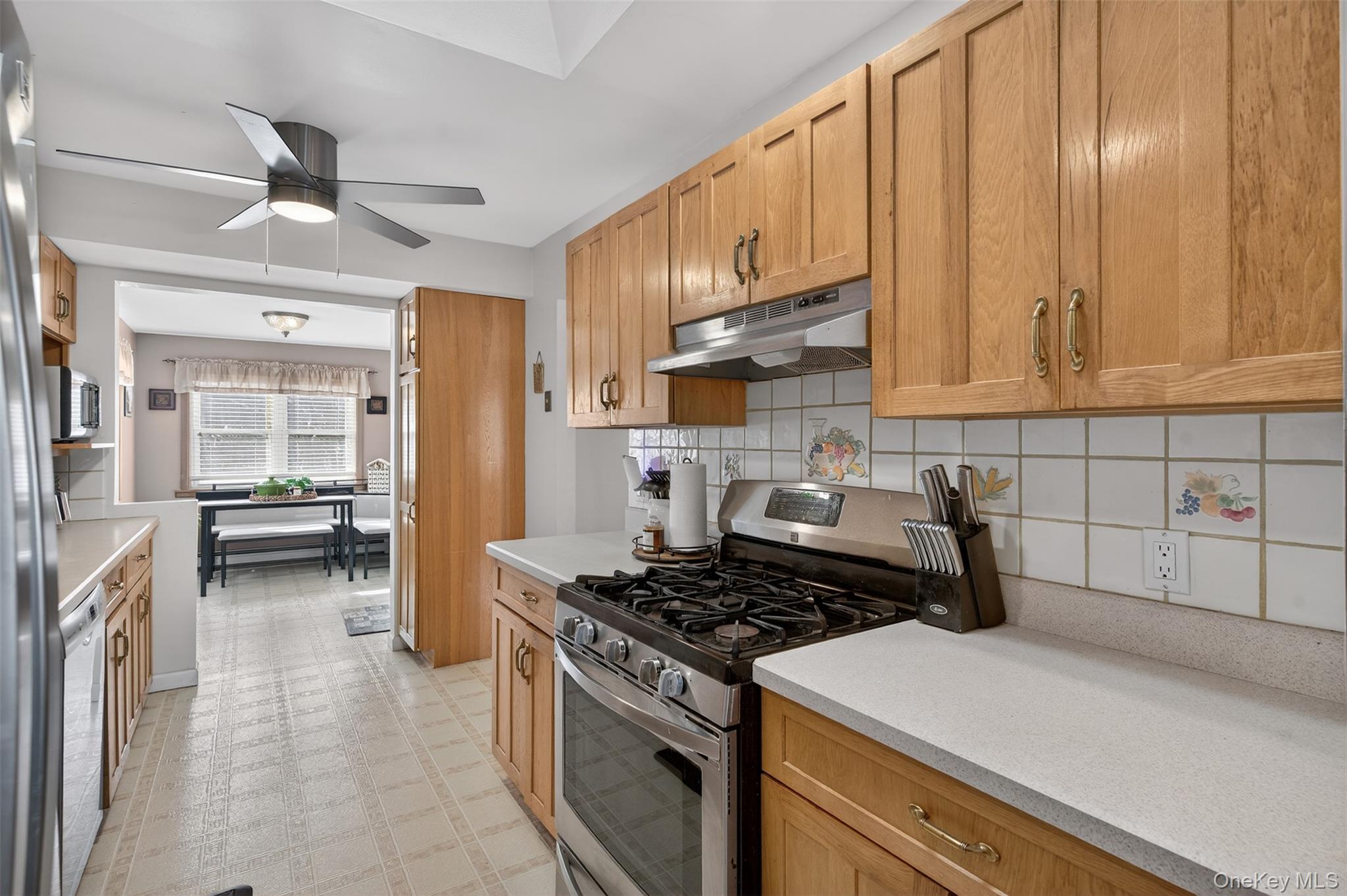 95 Sutton Park Road Poughkeepsie, NY 12603 - Photo 9 of 26 a kitchen with a stove a sink and a refrigerator