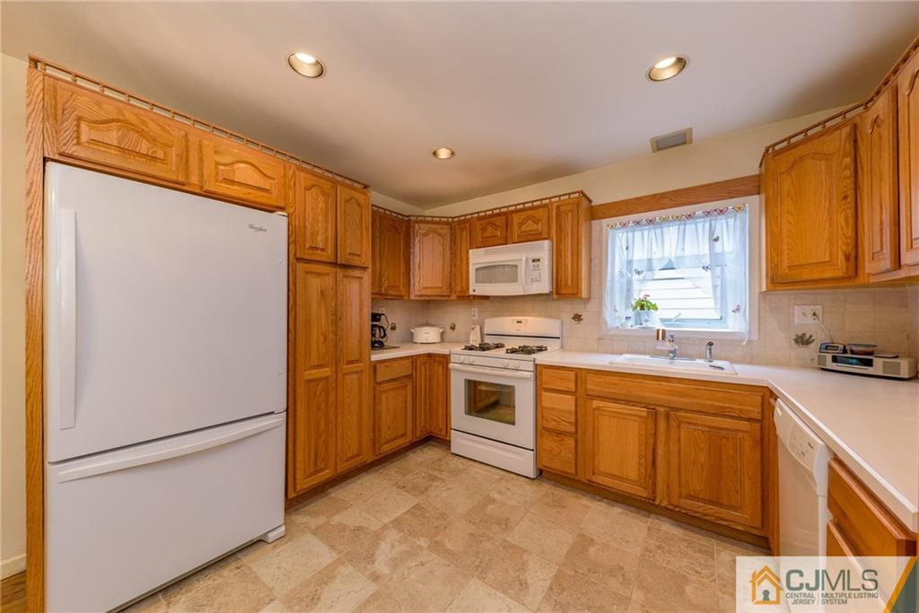 54 Phyllis Road West Orange, NJ 07052 - Photo 8 of 25 a kitchen with a refrigerator stove top oven and sink
