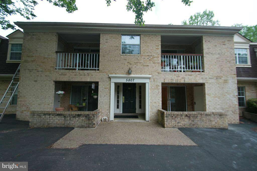 5807 Cove Landing Road, Unit 204 Burke, VA 22015 - Photo 1 of 17 a front view of a house with yard