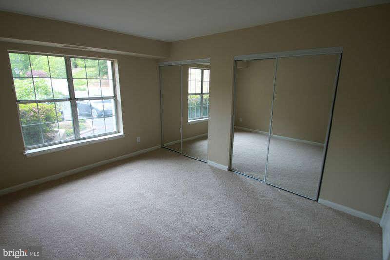 5807 Cove Landing Road, Unit 204 Burke, VA 22015 - Photo 6 of 17 an empty room with windows