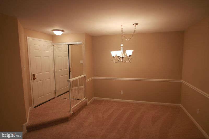 5807 Cove Landing Road, Unit 204 Burke, VA 22015 - Photo 8 of 17 a view of a room with a stylish ceiling fan and window