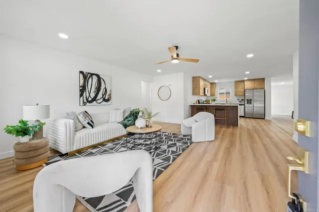 a living room with furniture and wooden floor