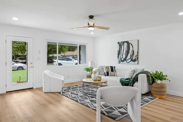a living room with furniture and a potted plant
