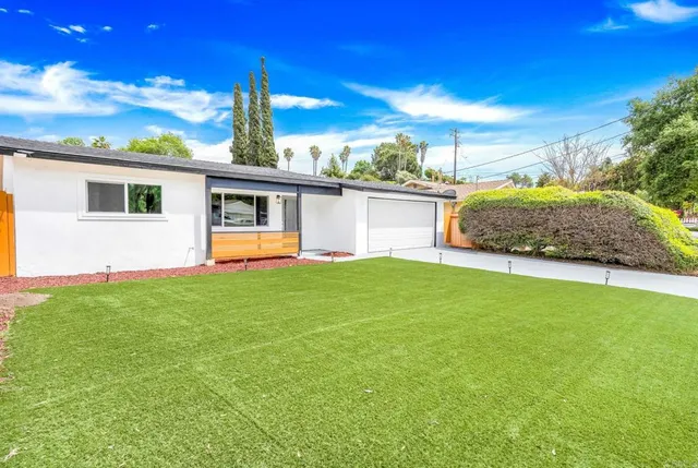 a view of a house with entertaining space and a view of a house