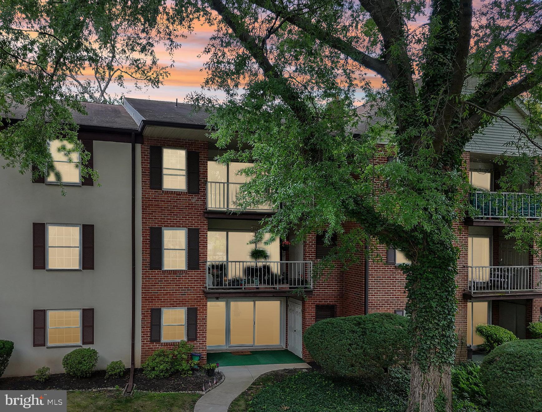 a front view of a house with a garden and plants