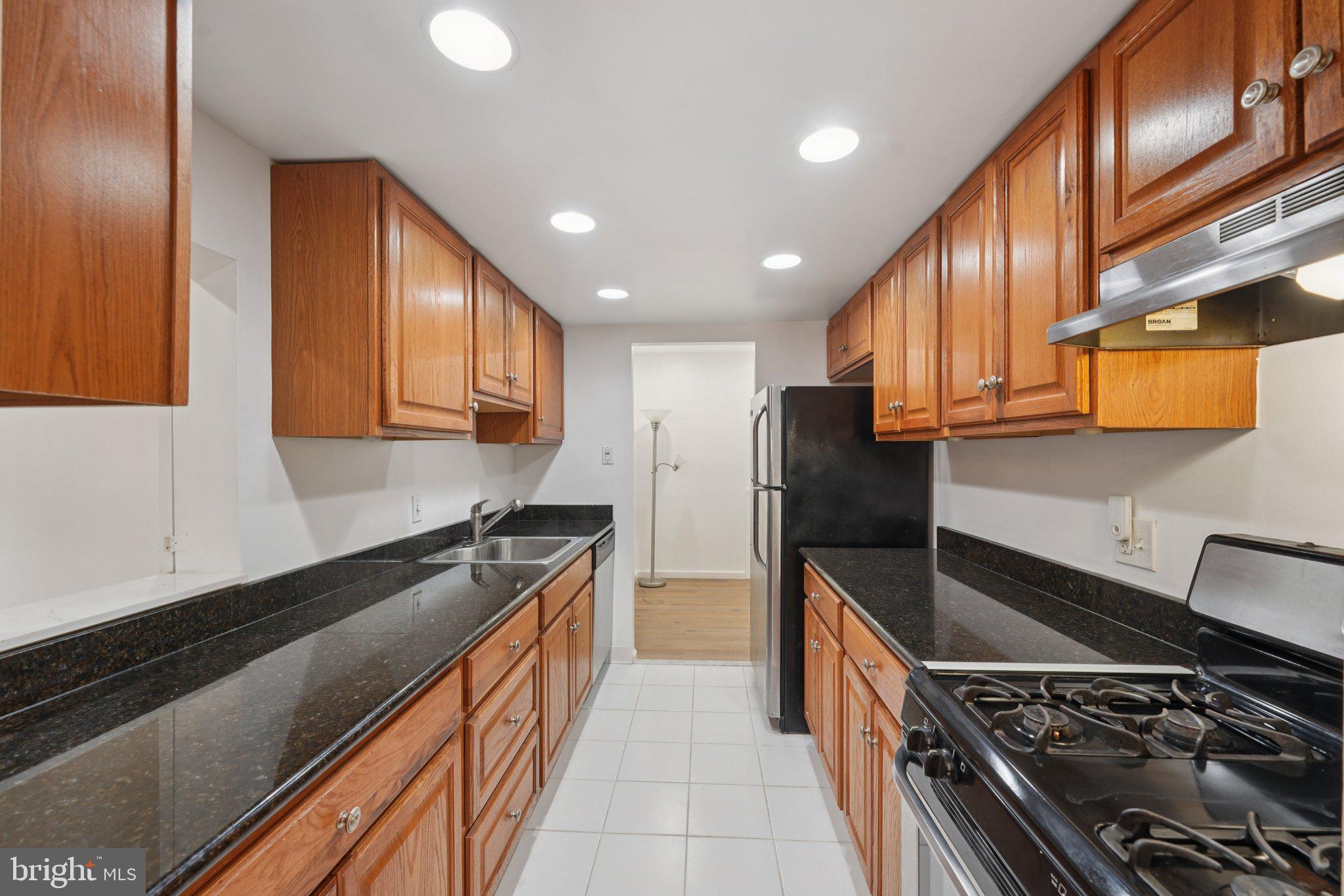 272 Drummers Lane Wayne, PA 19087 - Photo 14 of 46 a kitchen with stainless steel appliances granite countertop a stove top oven a sink and dishwasher