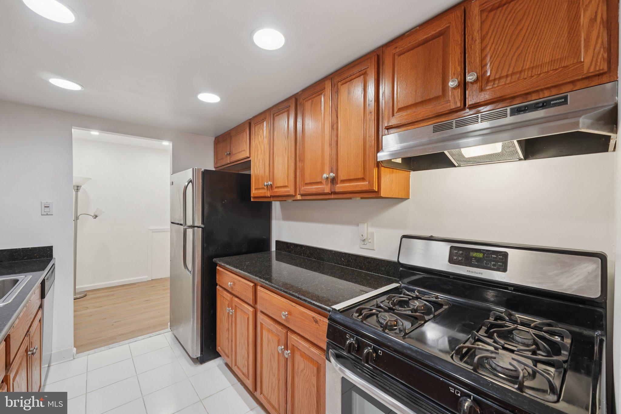 272 Drummers Lane Wayne, PA 19087 - Photo 15 of 46 a kitchen with stainless steel appliances granite countertop a stove and a refrigerator