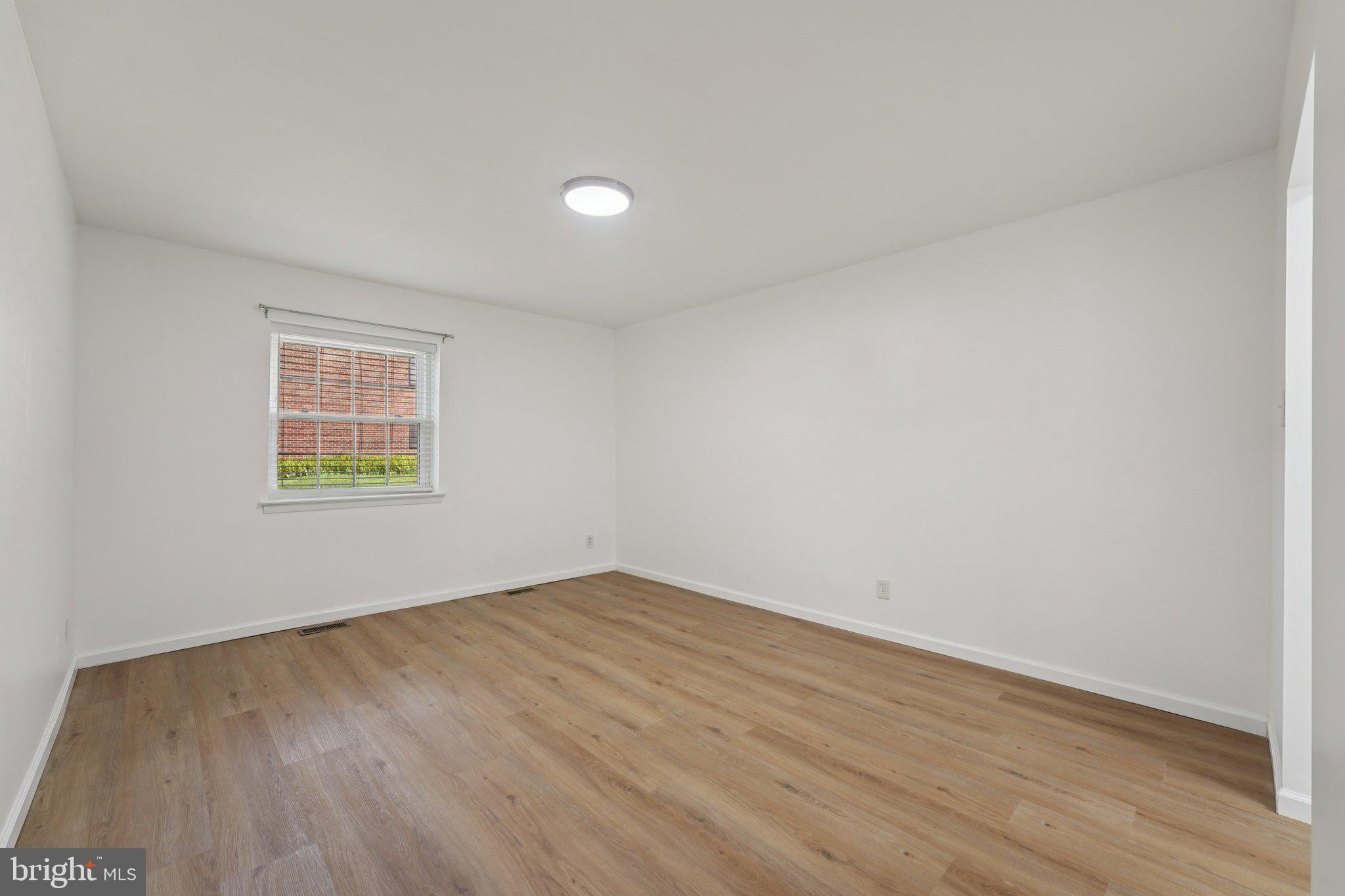 272 Drummers Lane Wayne, PA 19087 - Photo 20 of 46 an empty room with wooden floor and windows