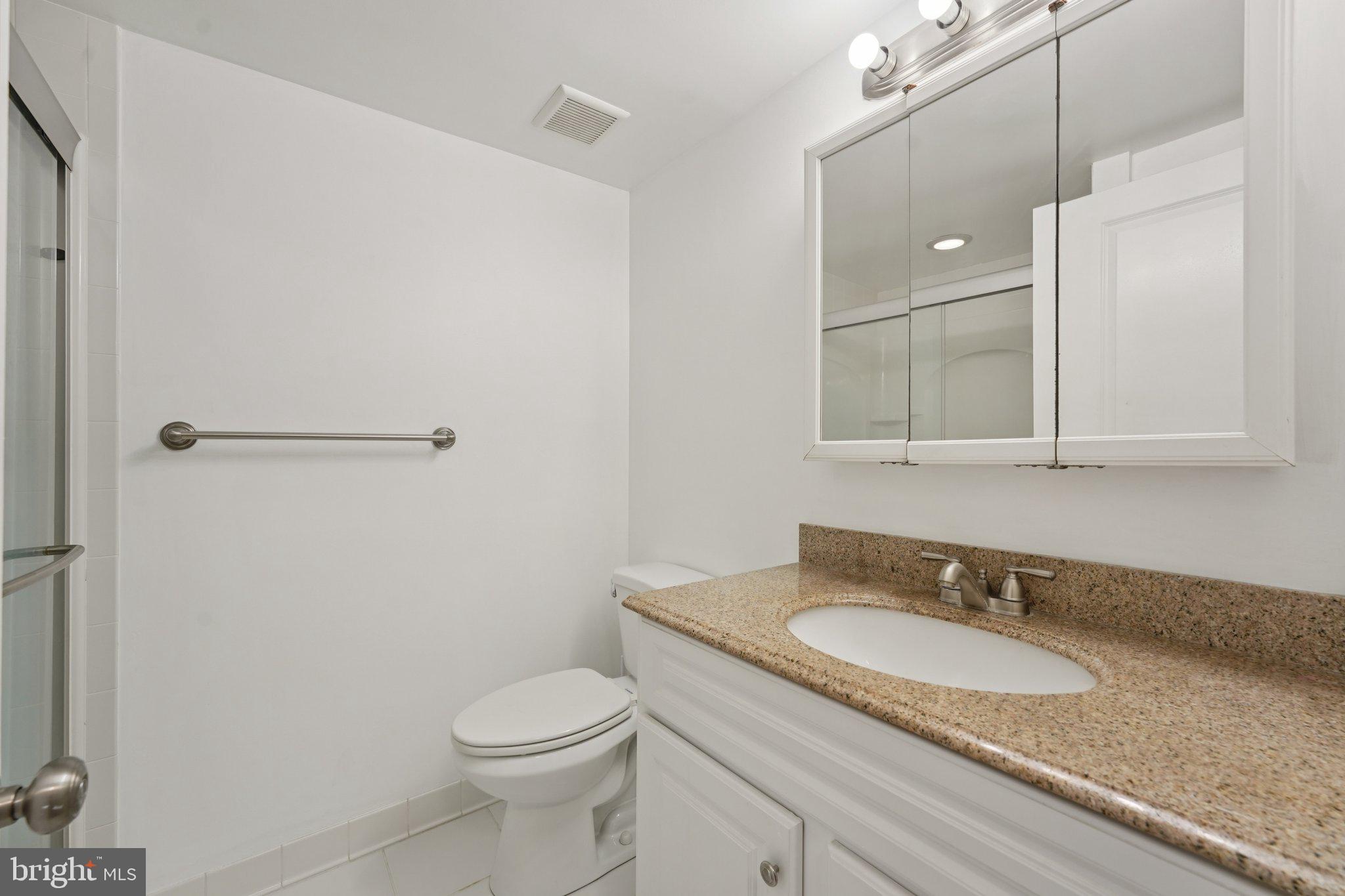 272 Drummers Lane Wayne, PA 19087 - Photo 22 of 46 a bathroom with a granite countertop sink toilet and a mirror