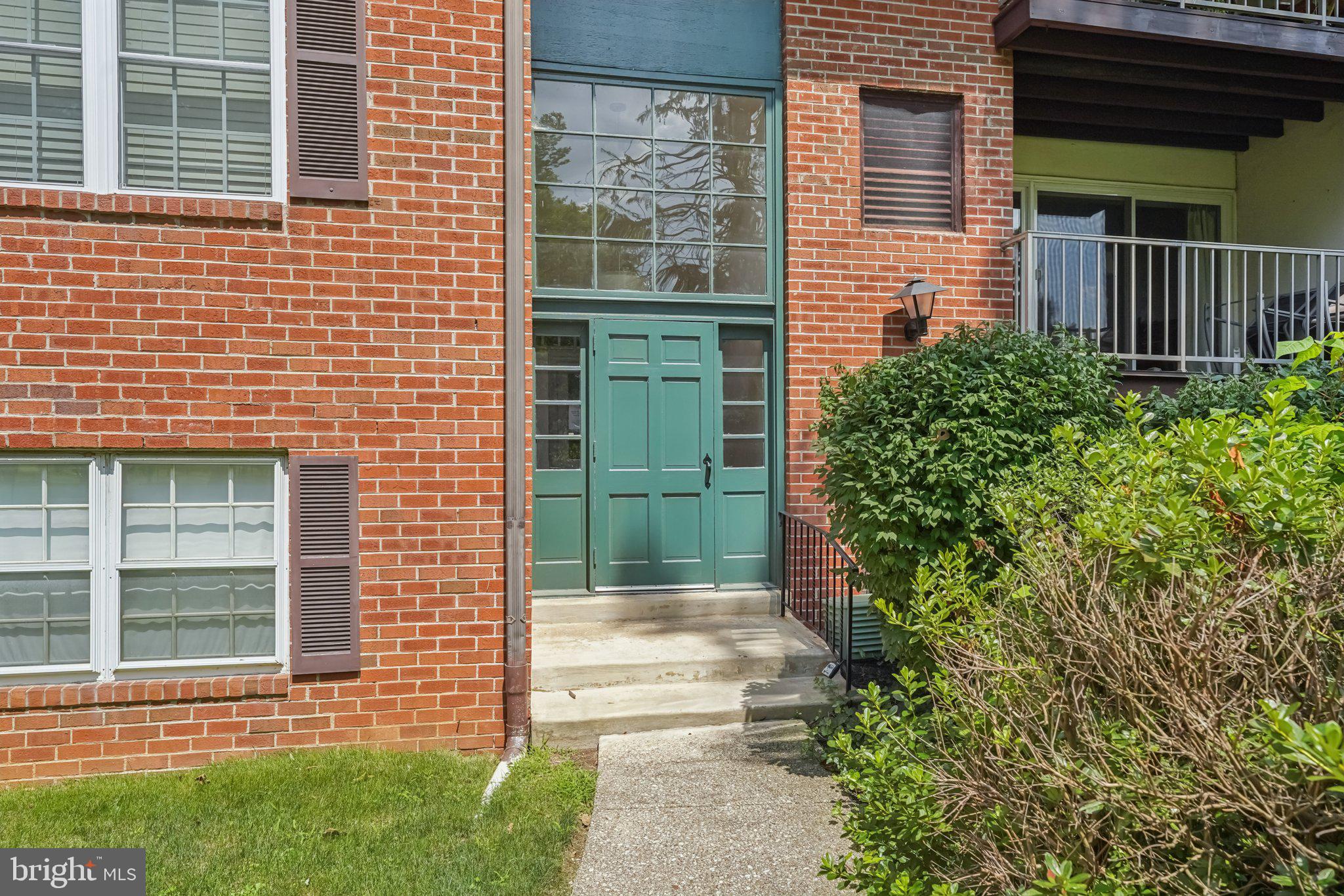 272 Drummers Lane Wayne, PA 19087 - Photo 27 of 46 a view of a brick house with a large windows and flower plants