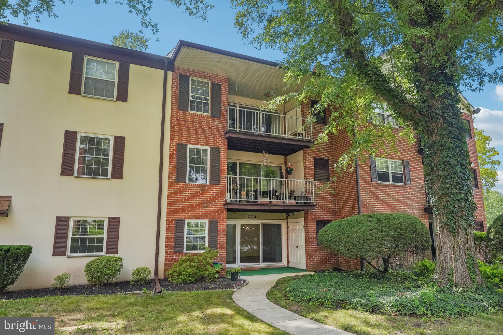 272 Drummers Lane Wayne, PA 19087 - Photo 29 of 46 a view of a brick house with a yard plants and large tree
