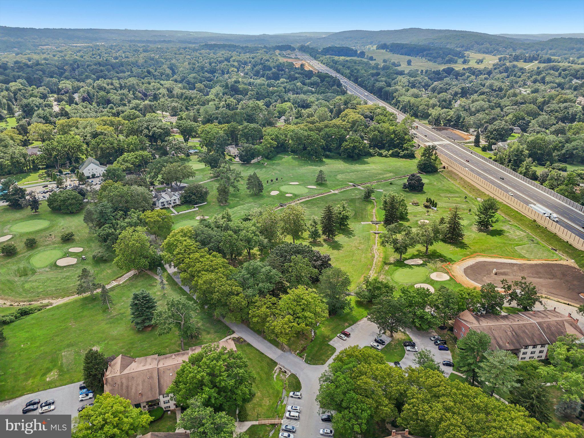 272 Drummers Lane Wayne, PA 19087 - Photo 39 of 46 an aerial view of green landscape with trees houses and mountain view