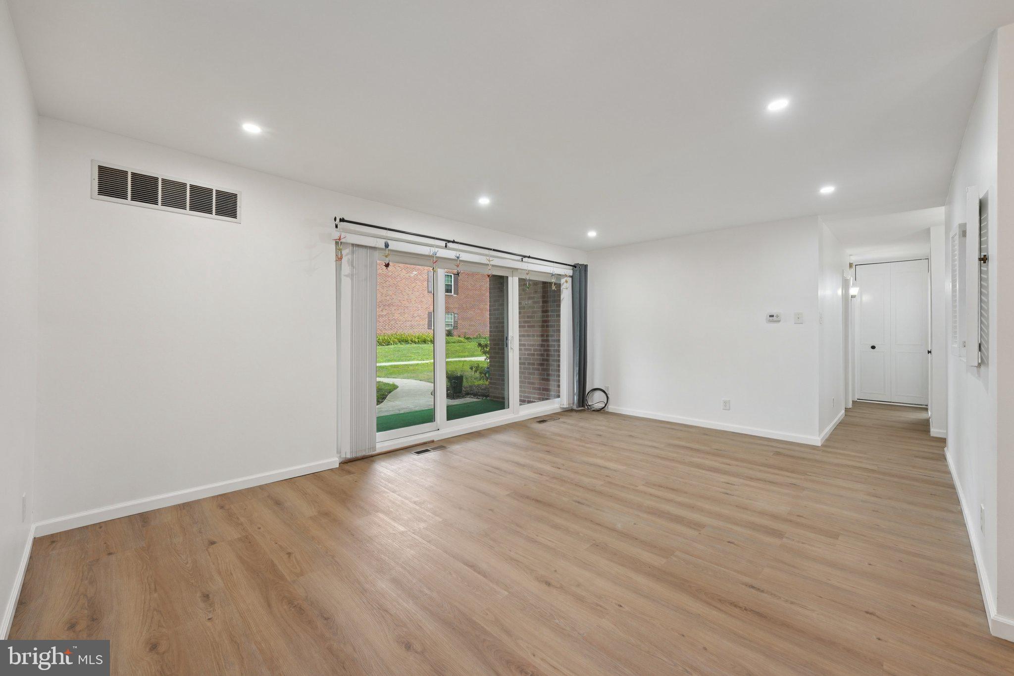 272 Drummers Lane Wayne, PA 19087 - Photo 6 of 46 a view of an empty room with wooden floor and a window
