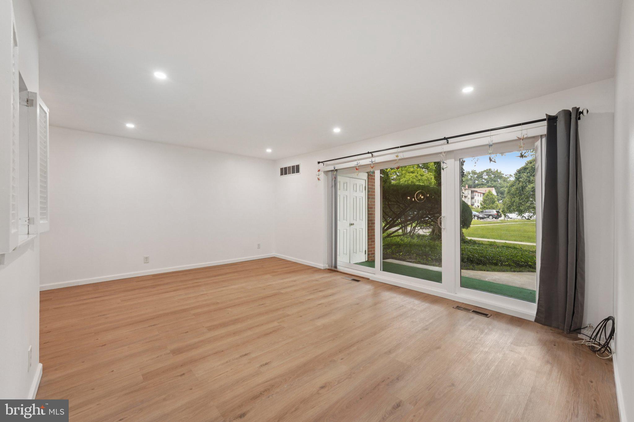 272 Drummers Lane Wayne, PA 19087 - Photo 8 of 46 a view of an empty room with wooden floor and a window