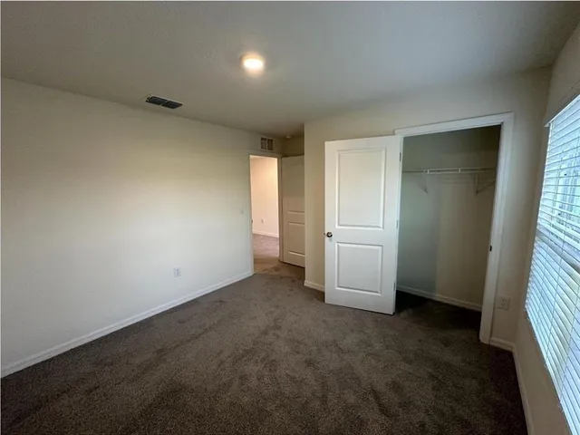 a view of a back yard from a corridor