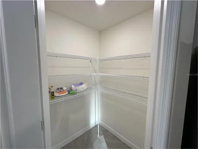 a view of storage and utility room with closet