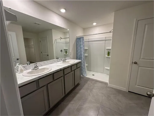 an empty room with closet area and a window