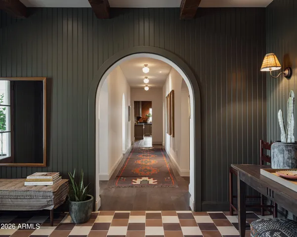 a view of a hallway with livingroom and furniture
